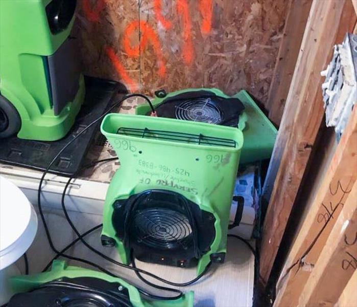 Dehumidifier and air movers in bathroom.