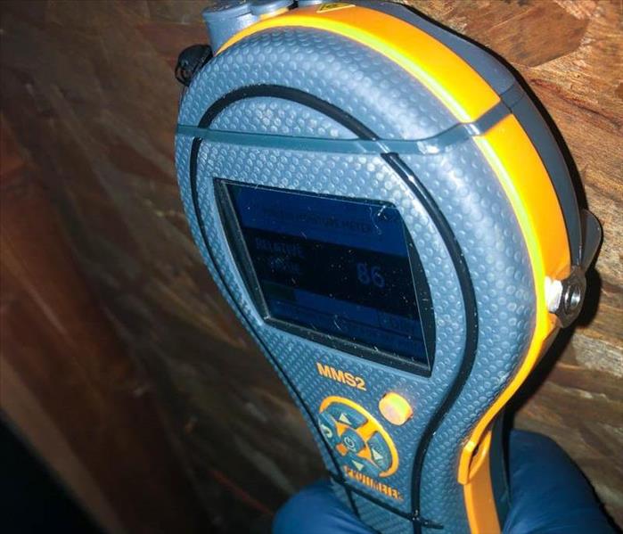 Moisture meter on the inside of a roof.