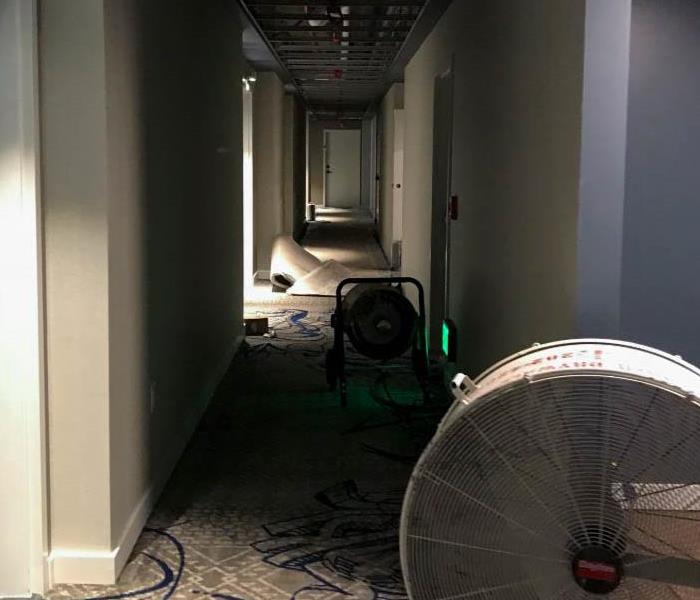 Hallway in commercial building with fans.